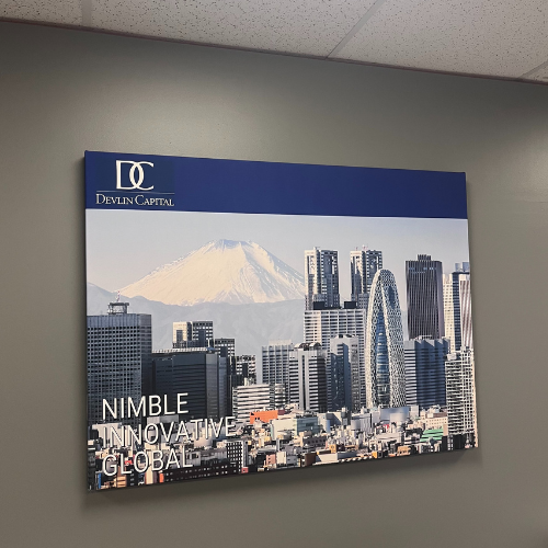 A large, professional Canvas Wrap, featuring a striking cityscape with Mount Fuji in the background. Branded with their logo and core values, this piece adds a bold corporate presence to their office wall.